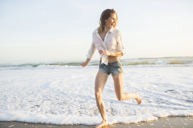 Caucasian woman playing on beach