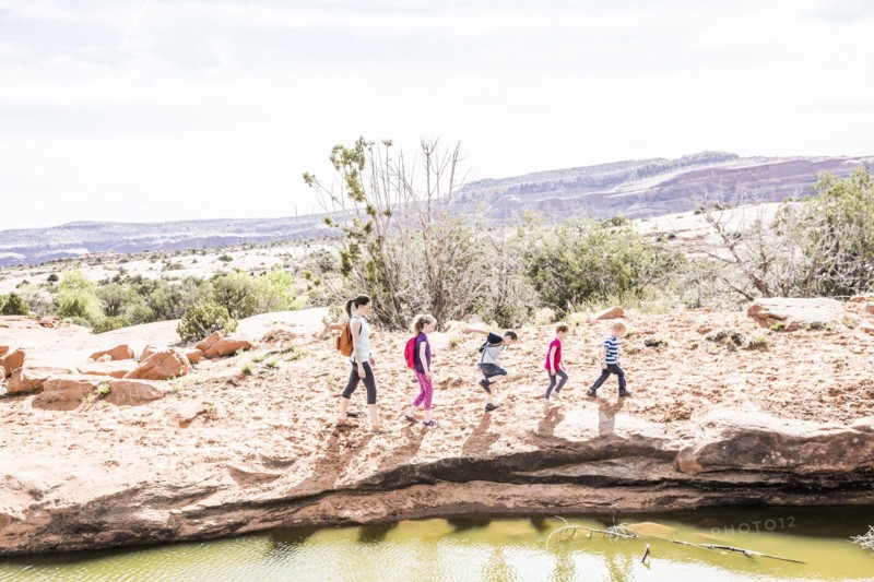 Caucasian mother and children hiking near river