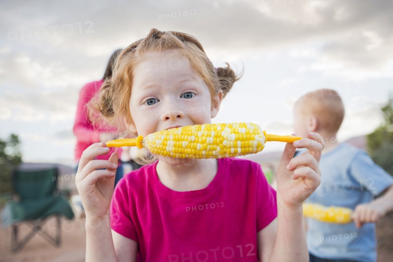 Caucasian girl eating corn on the cob