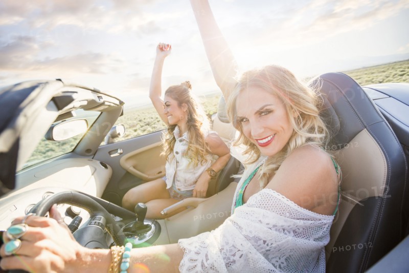 Caucasian women driving in sports car