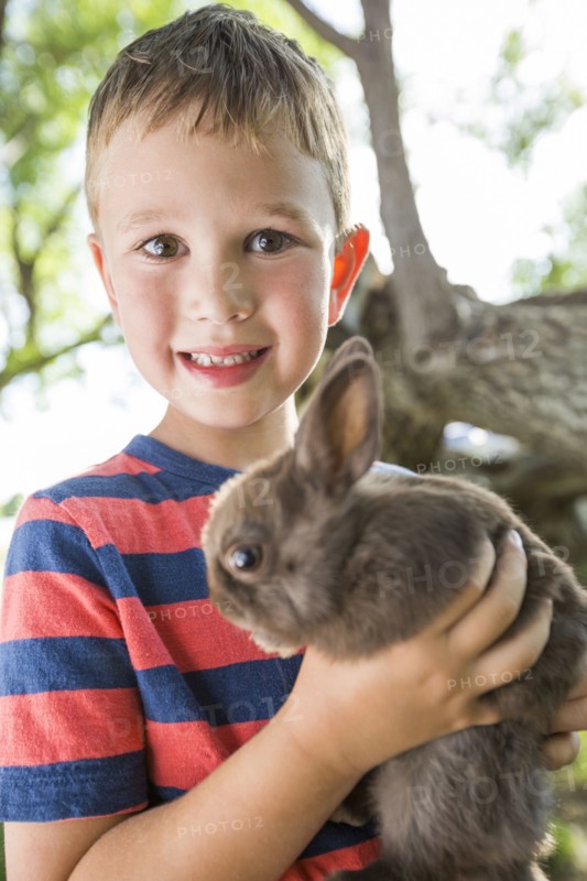 Caucasian boy holding rabbit