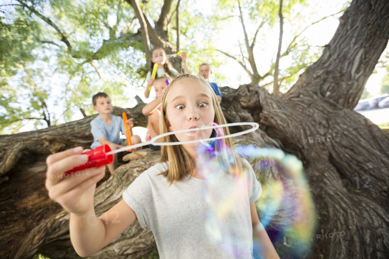 Caucasian girl making bubbles