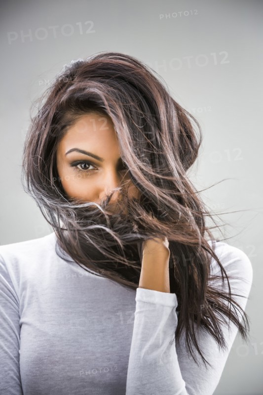 Hair blowing in face of Indian woman