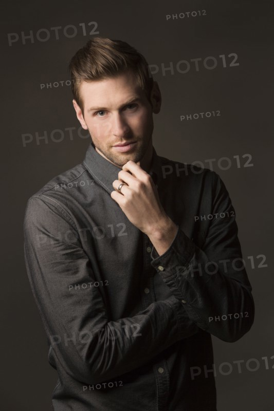 Serious Caucasian man with hand on chin