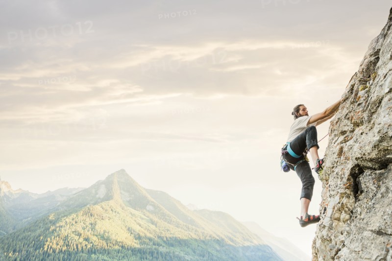 Caucasian man rock climbing