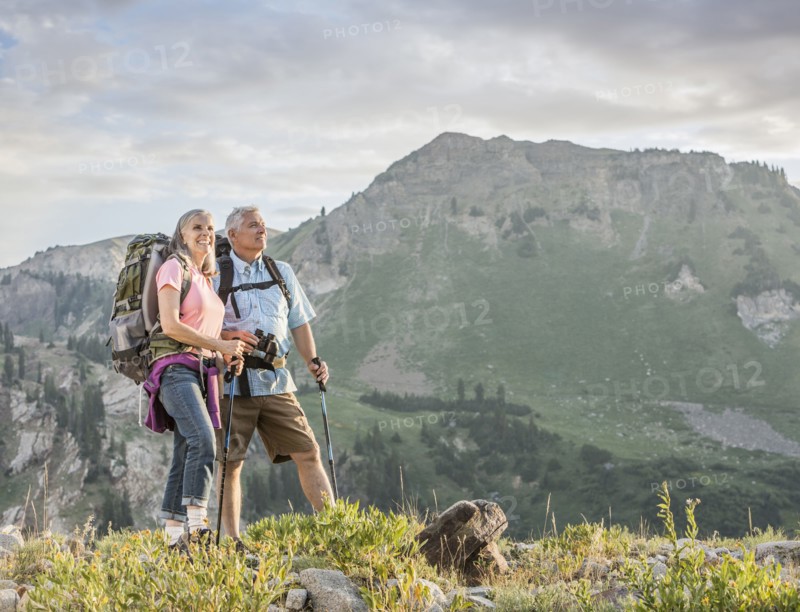 Caucasian couple hiking on mountain