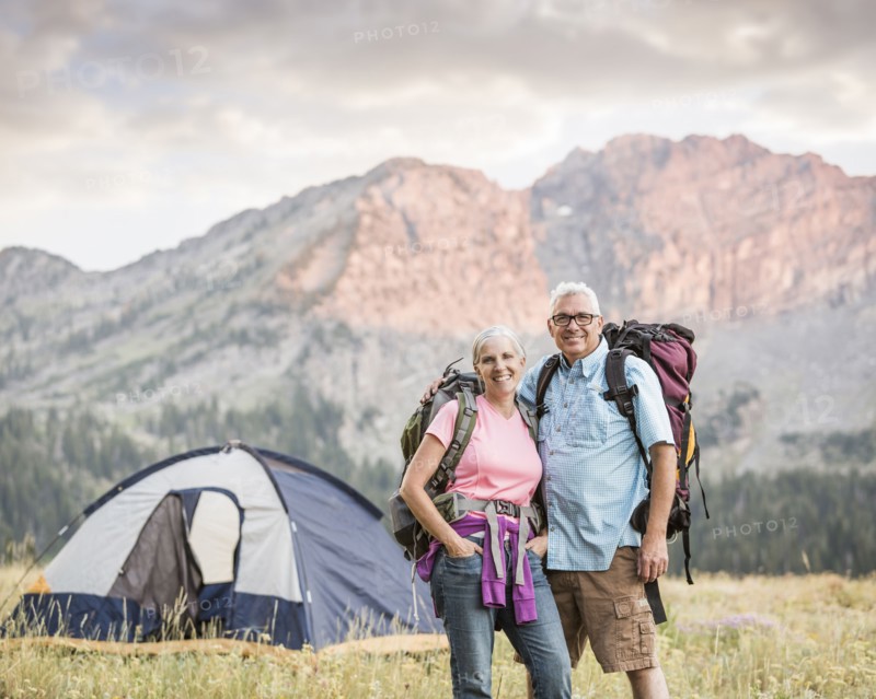 Caucasian couple camping on mountain