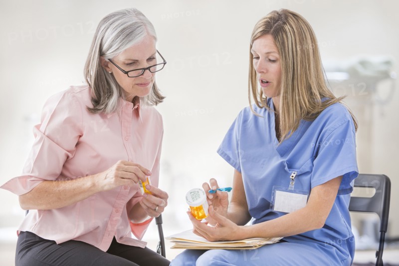 Caucasian nurse explaining prescription to patient