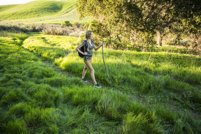 Caucasian woman hiking on hill