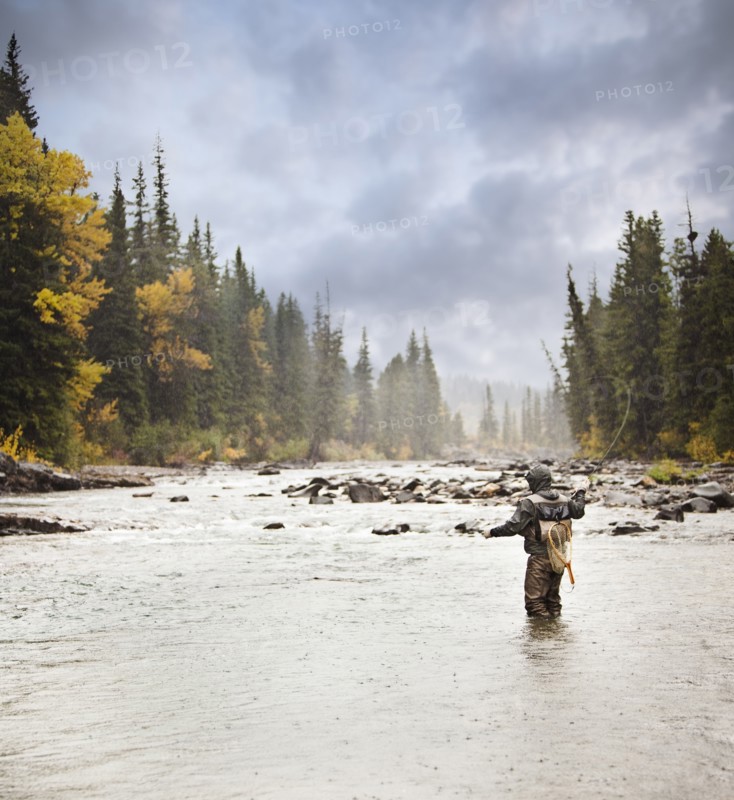Caucasian man fishing in river