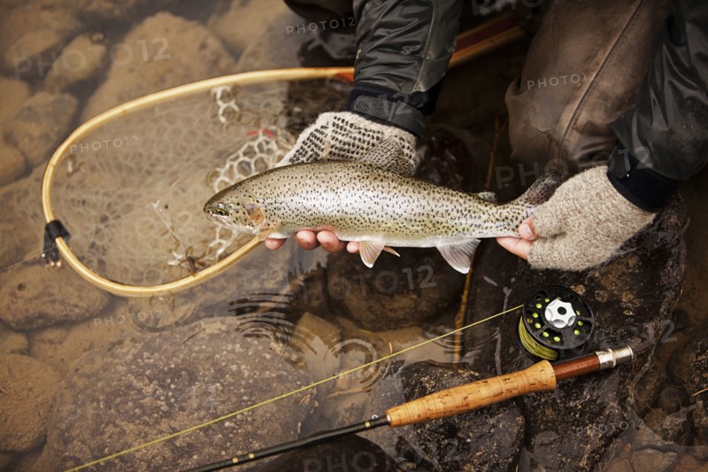 Caucasian man showing caught fish