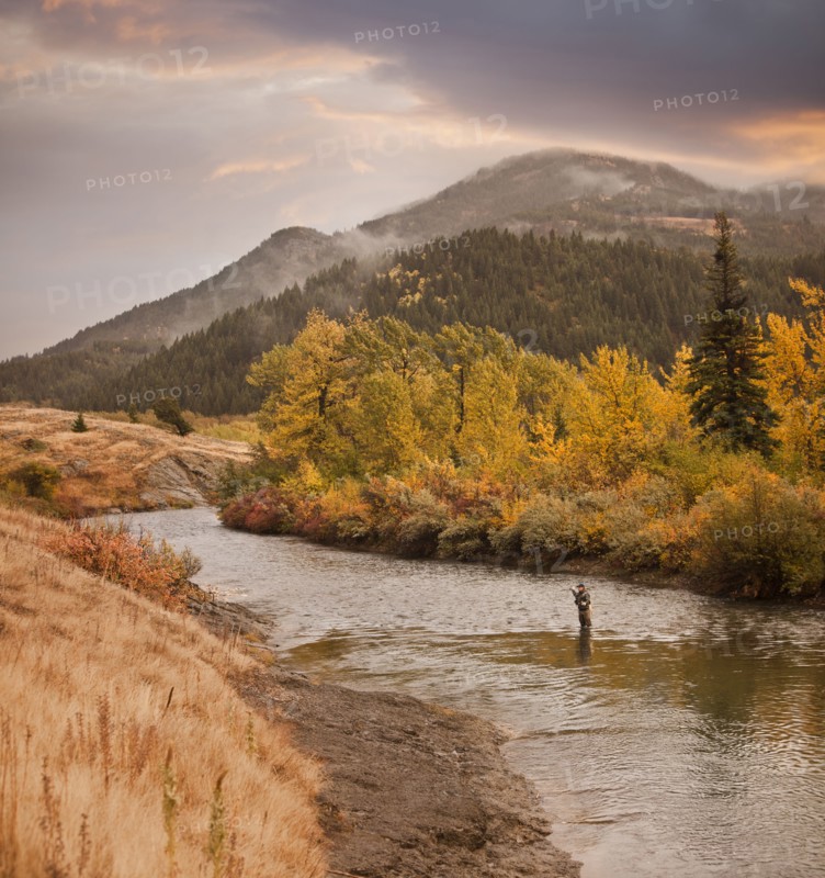 Caucasian man fishing in river