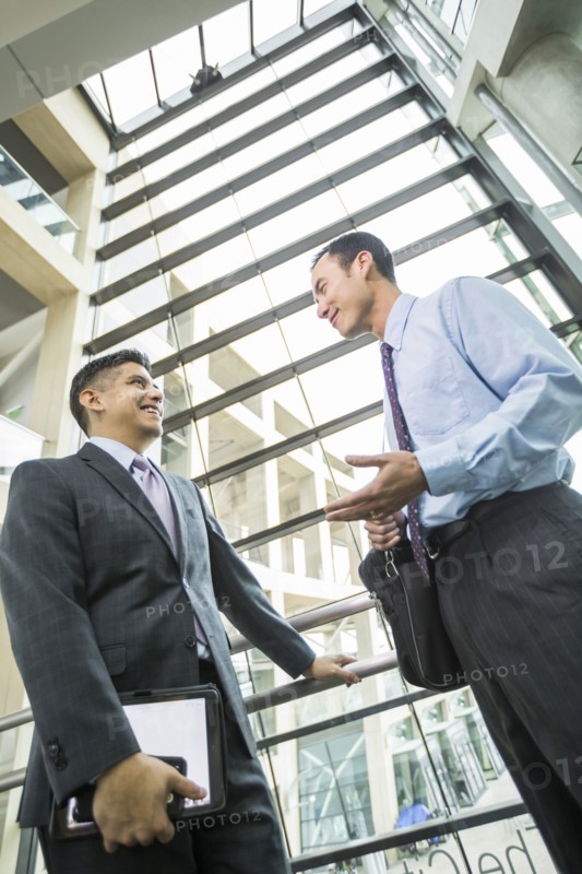 Smiling businessmen talking in lobby