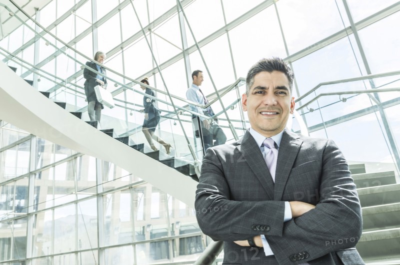 Portrait of businessman standing near staircase