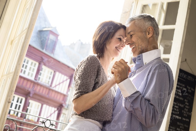 Caucasian couple dancing near doorway