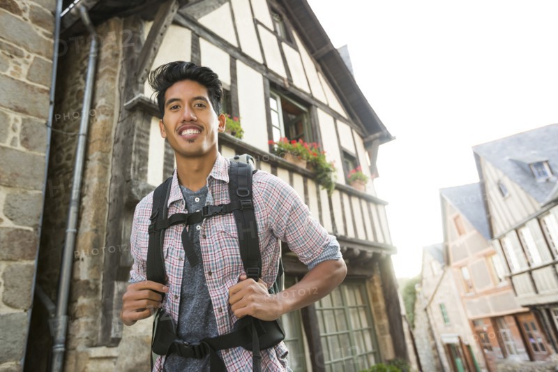 Asian man backpacking in city