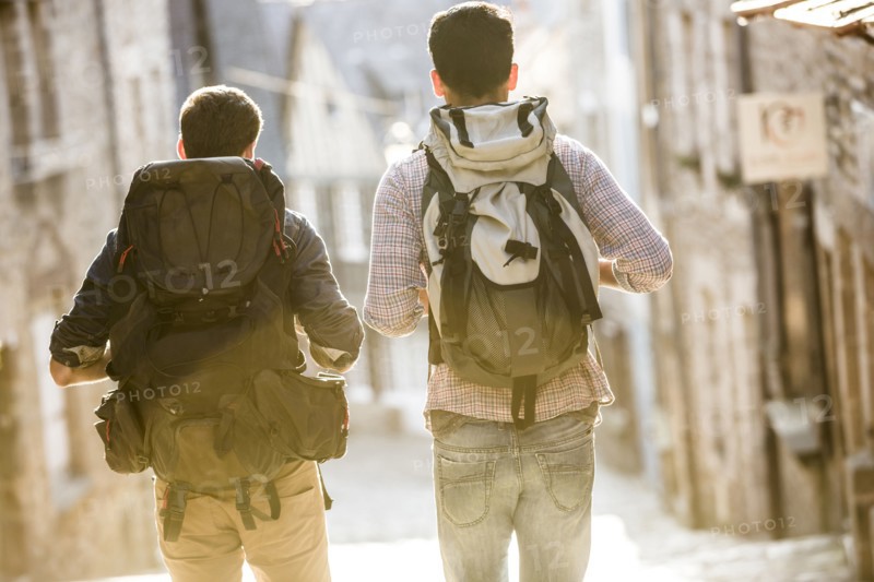 Men backpacking in city