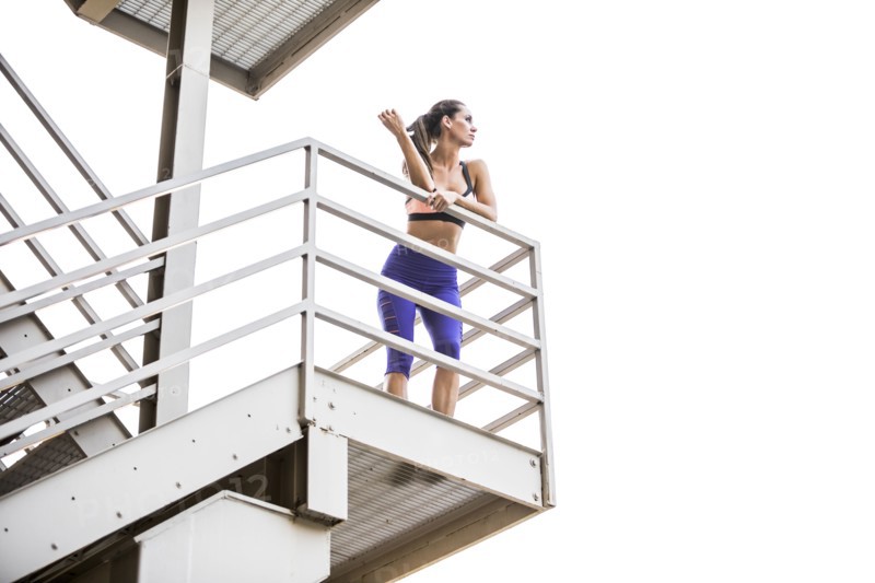 Caucasian woman leaning on urban staircase