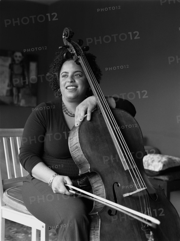 Mixed race woman playing cello