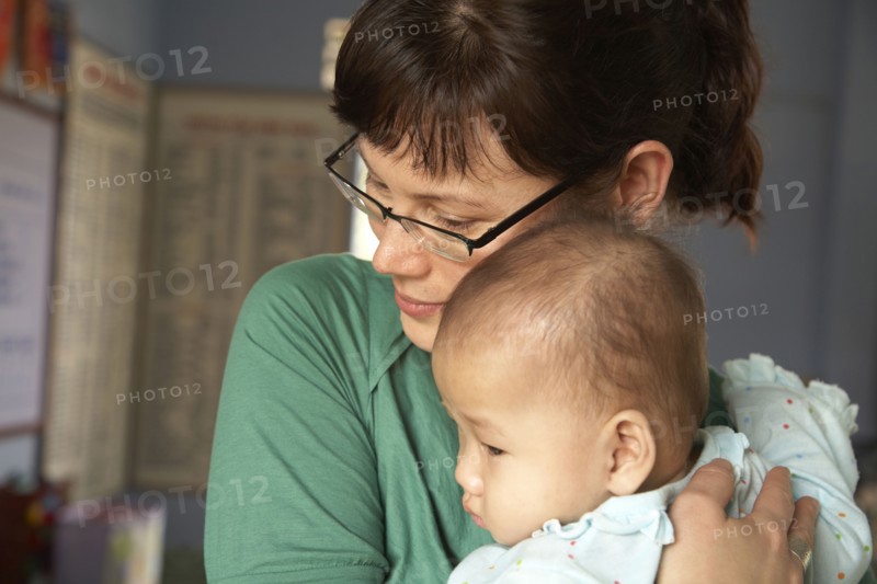 Mother hugging baby