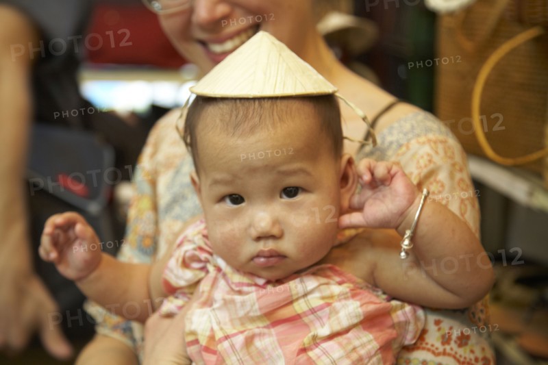 Baby girl wearing Asian hat