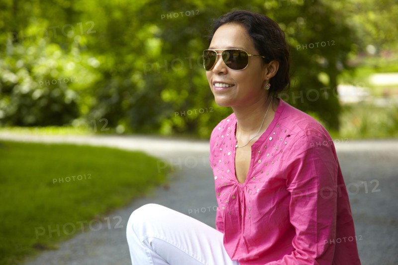 Smiling mixed race woman sitting outdoors