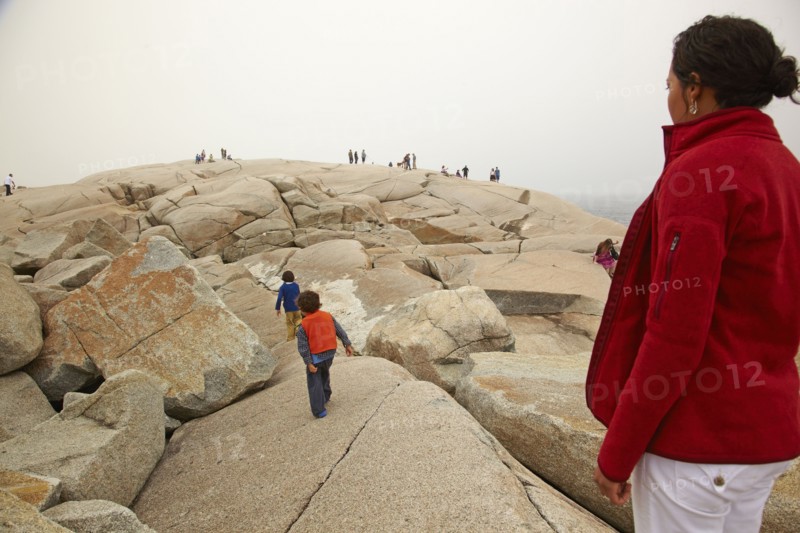 Mother and sons walking on rocks