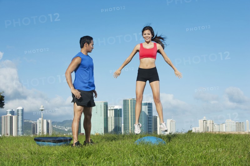 Couple exercising together in field