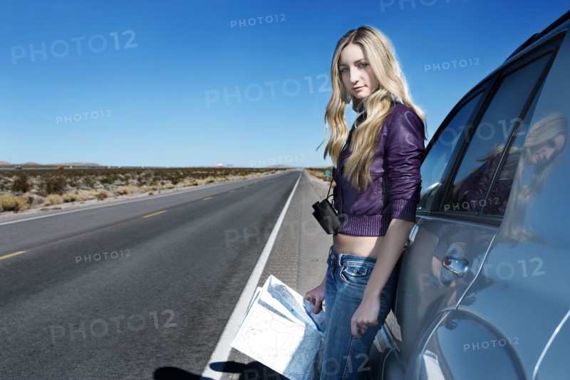 Caucasian woman reading map at roadside