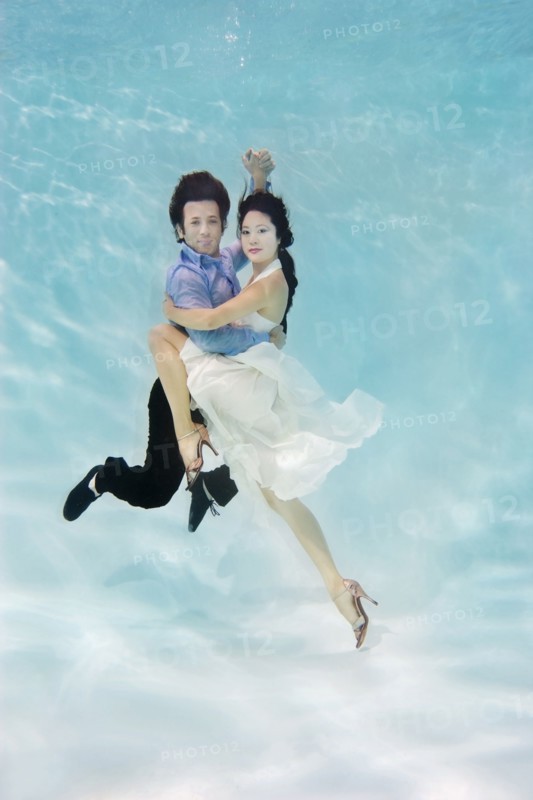 Couple dancing under water