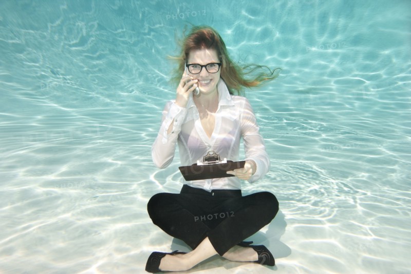 Caucasian businesswoman sitting underwater