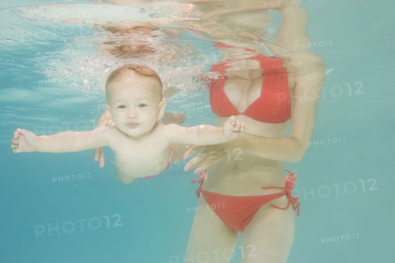 Caucasian baby swimming underwater