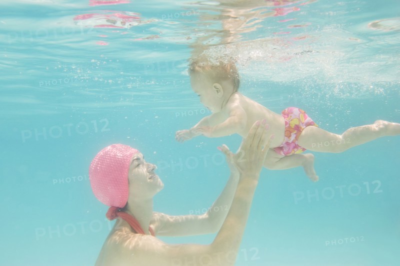 Caucasian baby swimming underwater
