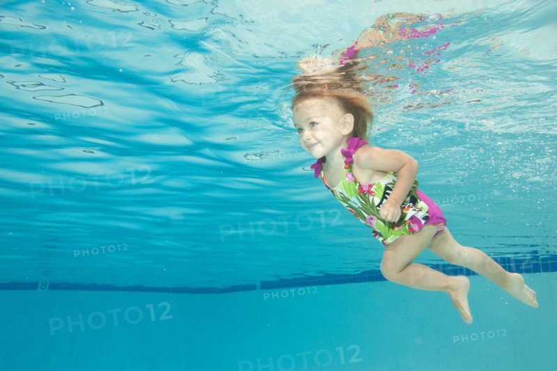 Underwater view of Caucasian girl swimming in pool