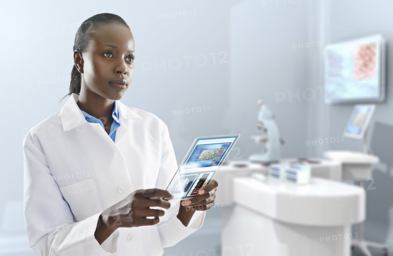 African American doctor using digital tablet in laboratory