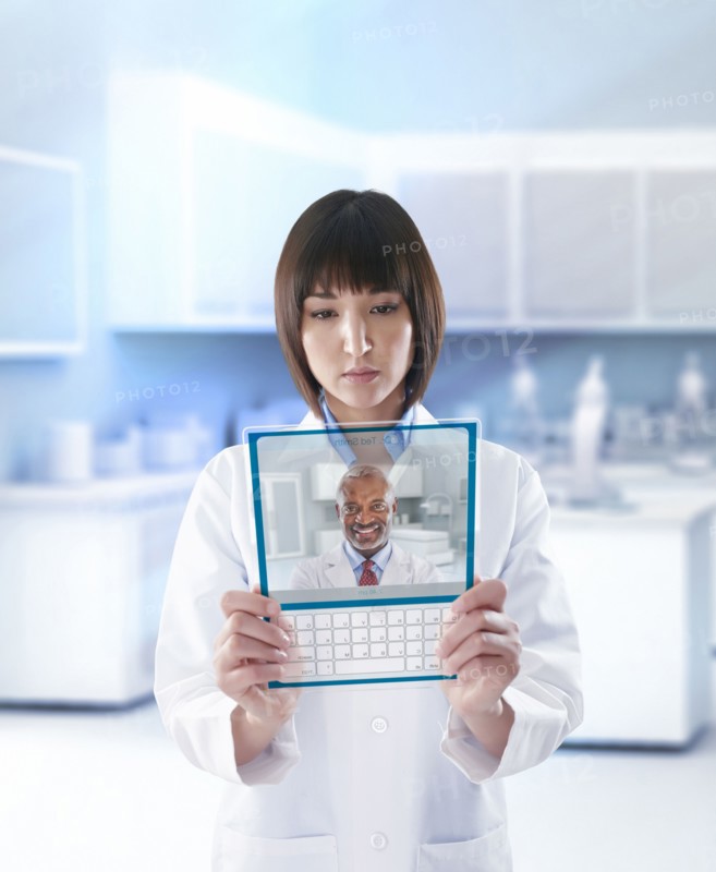 Mixed race doctor using digital tablet in a lab