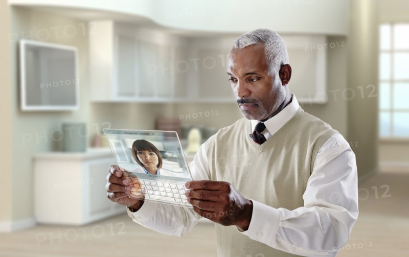 Black businessman using digital tablet in office