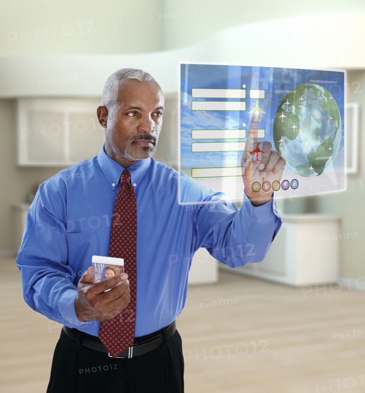 Black businessman using digital display in office