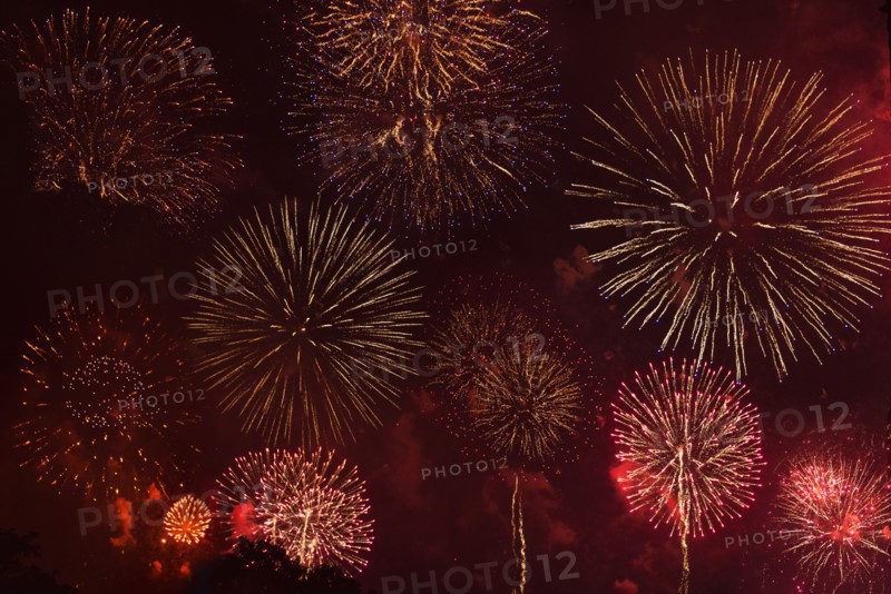 Fireworks exploding in red sky