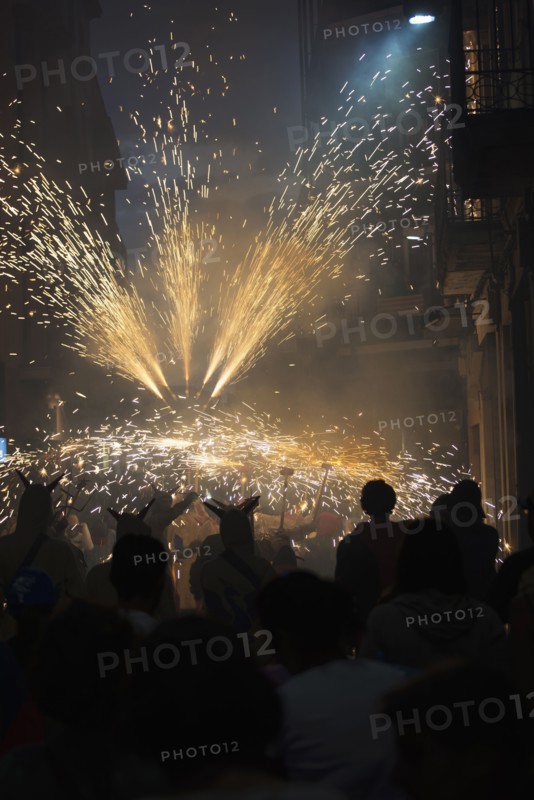 Crowd watching sparks in parade at night