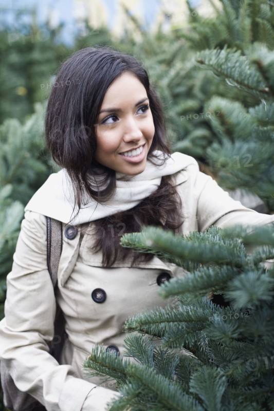 Middle Eastern woman looking at pine trees