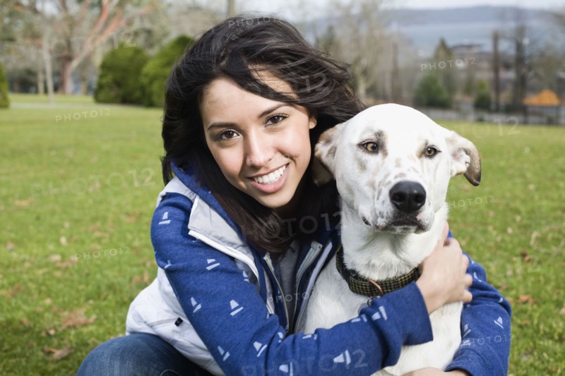 Middle Eastern woman hugging dog