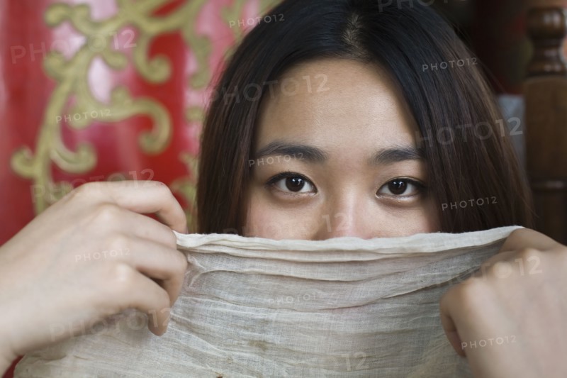 Chinese woman hiding behind scarf