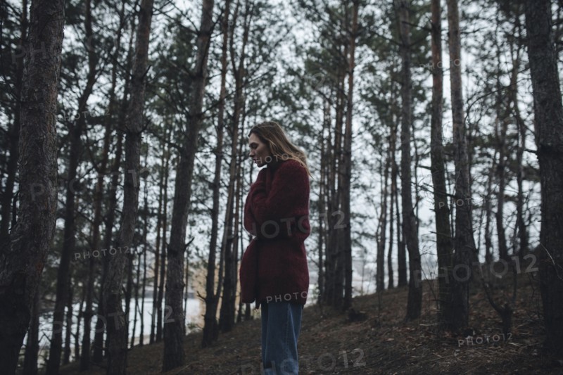 Caucasian woman standing near trees