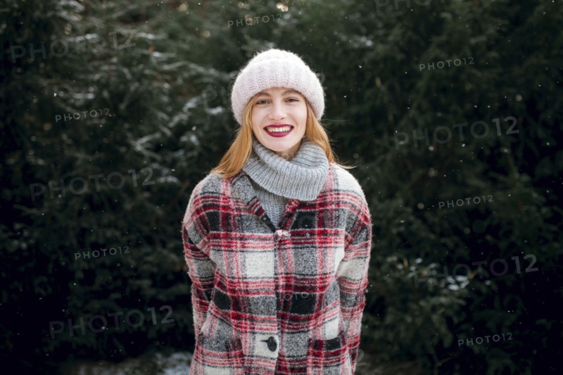 Caucasian woman smiling near trees