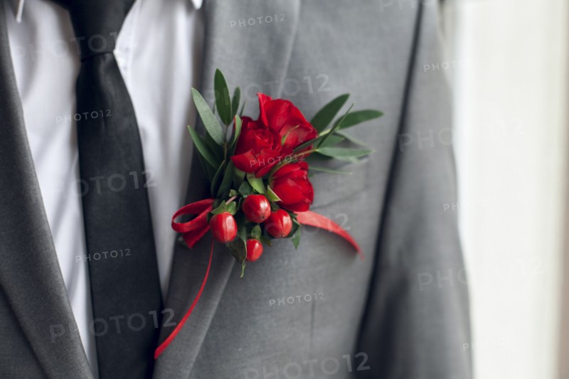 Red corsage on suit jacket
