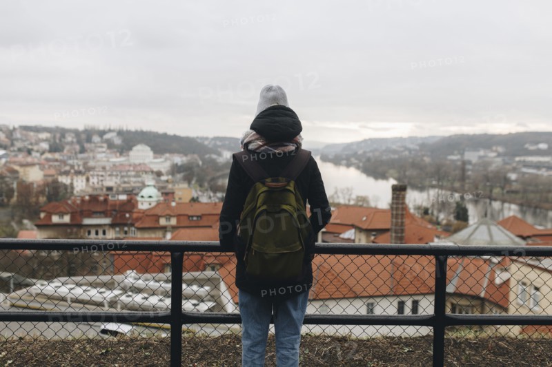 Caucasian woman wearing backpack admiring scenic view of city
