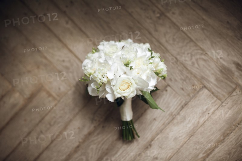 Bouquet of white roses on floor