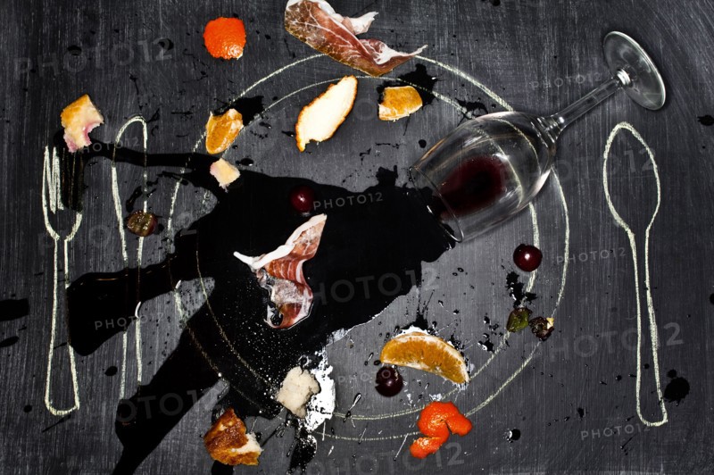 Wine glass and food spilled onto chalkboard