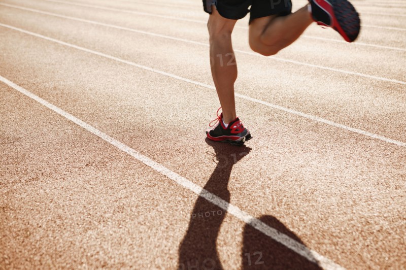 Male athlete running on a track